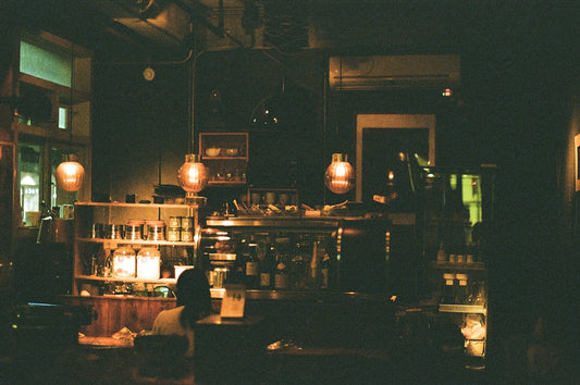 a dimly lit room with a counter and shelves