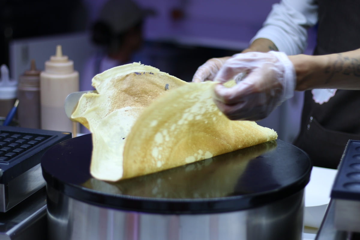 a person in a kitchen preparing food on a stove