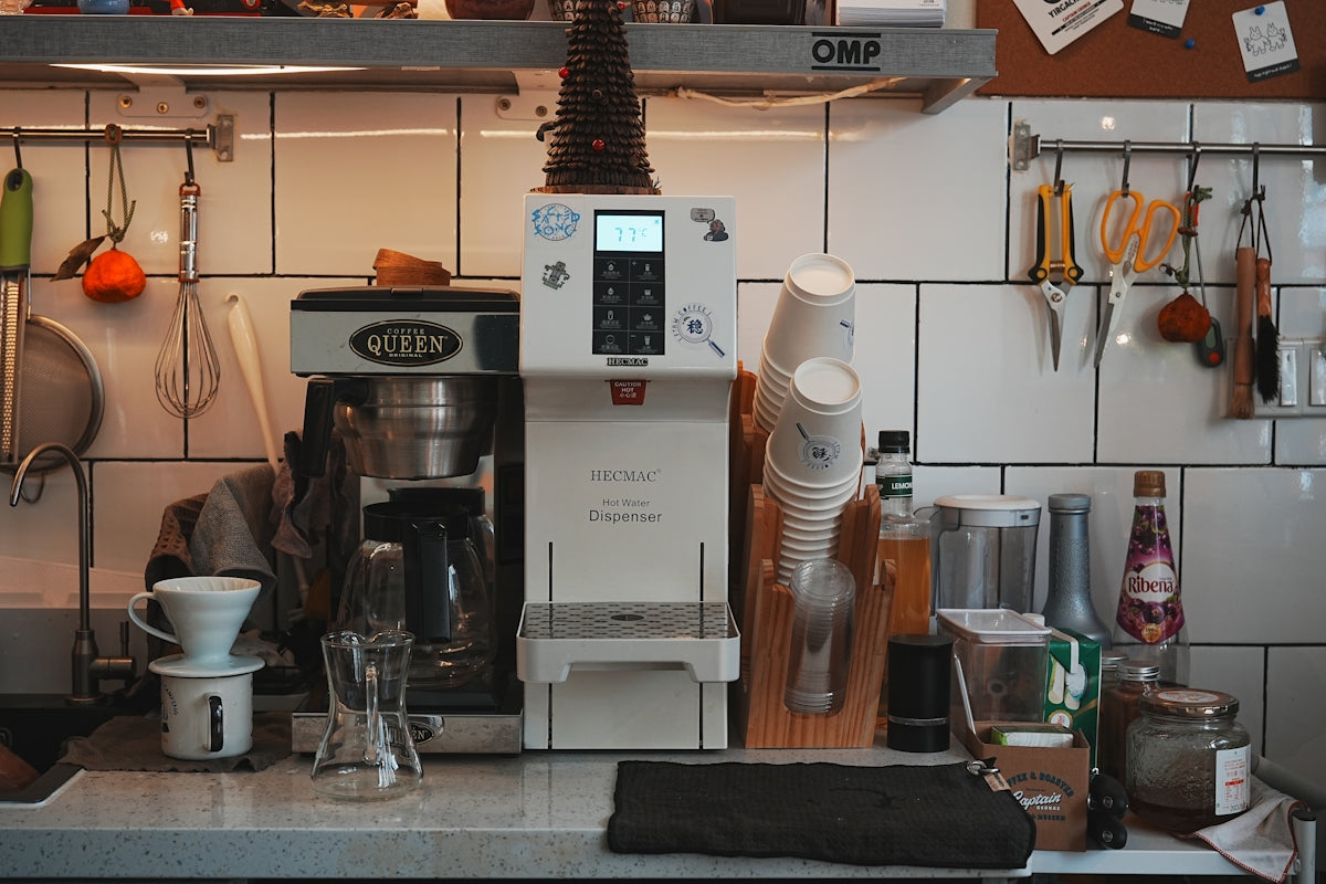 A kitchen counter with a coffee maker and other kitchen items