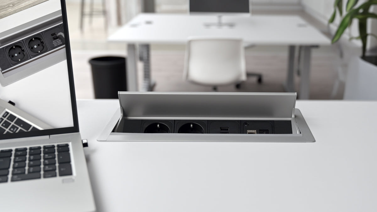 A laptop computer sitting on top of a white table